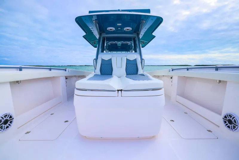 Slide: The Image of 2024 Invincible 46 Catamaran with sleek design and spacious deck under a cloudy sky. - 8