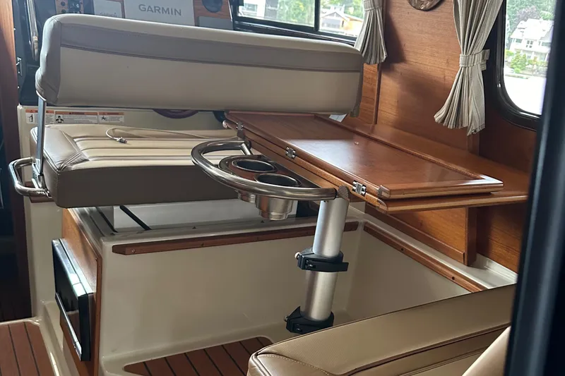 Slide: The Image of Interior of 2021 Ranger Tugs R-27 boat with seating and wooden table. - 5