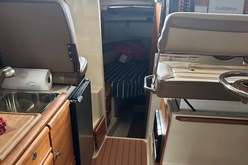 Slide: The Image of Interior of 2021 Ranger Tugs R-27 boat showing kitchen, seating, and sleeping area. - 7