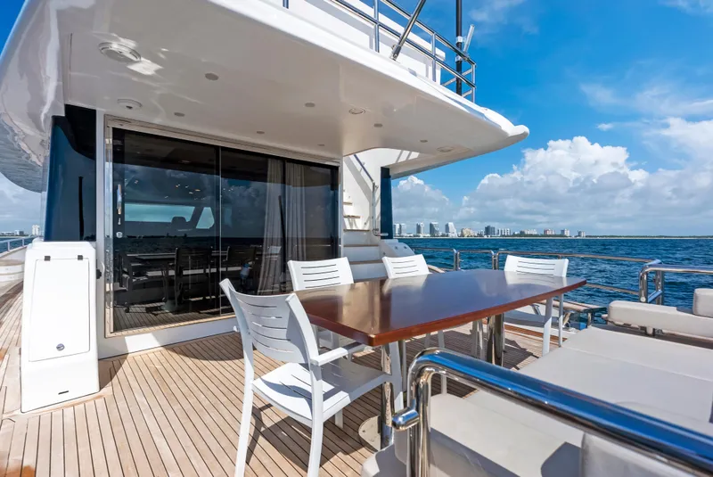 Slide: The Image of Luxurious 2016 Azimut Magellano 76 yacht deck with dining area, ocean view. - 16