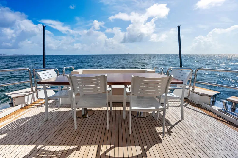 Slide: The Image of Deck view of 2016 Azimut Magellano 76 yacht with ocean backdrop and seating area. - 17