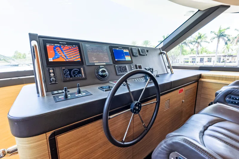 Slide: The Image of Helm of 2016 Azimut Magellano 76 yacht with navigation screens and leather seating. - 26