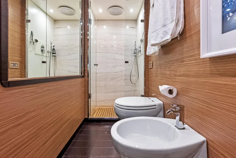 Slide: The Image of Luxurious bathroom on 2016 Azimut Magellano 76 yacht with modern fixtures and wooden accents. - 32