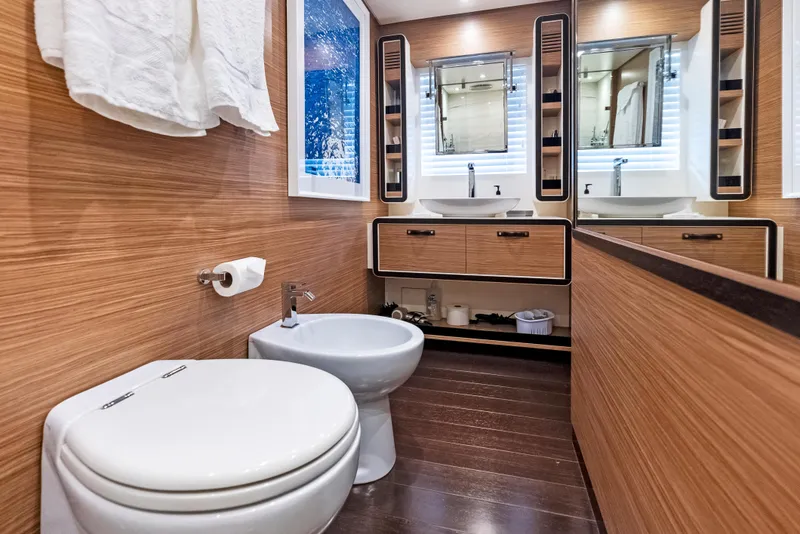 Slide: The Image of Luxurious bathroom in 2016 Azimut Magellano 76 yacht with wood paneling and dual sinks. - 33