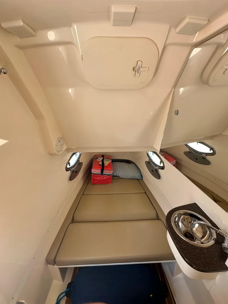 Slide: The Image of Interior cabin of 2018 Scout 300 LXF boat with seating and portholes. - 20