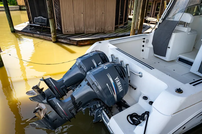 Slide: The Image of 2003 Aquasport 275 Explorer with twin Yamaha outboard engines docked. - 10