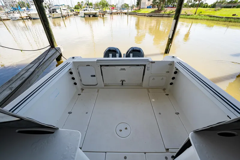 Slide: The Image of 2003 Aquasport 275 Explorer boat stern view at a marina. - 11