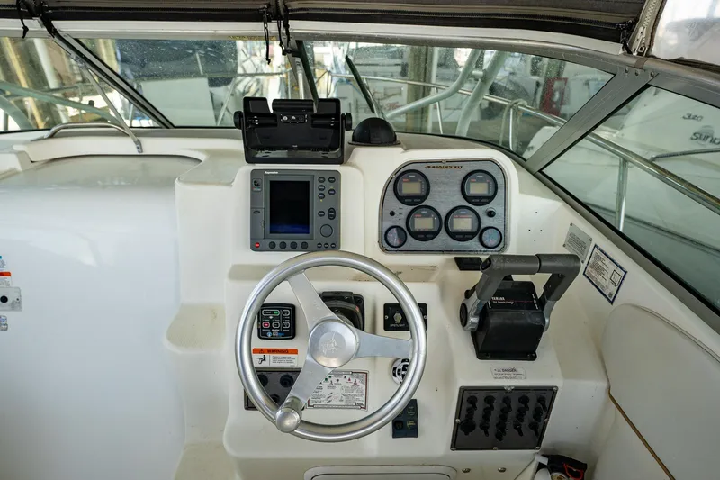 Slide: The Image of 2003 Aquasport 275 Explorer boat helm with steering wheel and navigation instruments. - 15