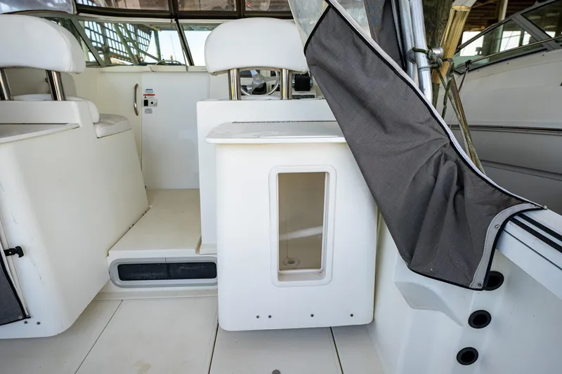 Slide: The Image of 2003 Aquasport 275 Explorer boat interior with seating and storage compartment. - 16