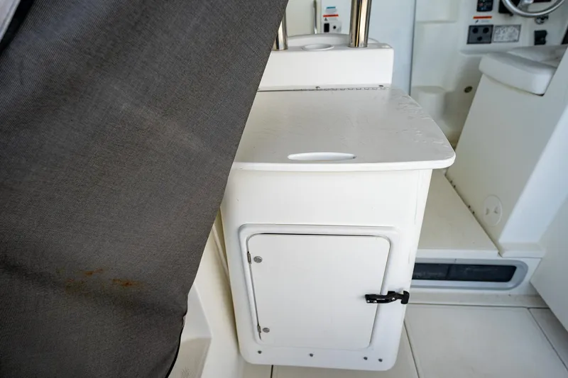 Slide: The Image of 2003 Aquasport 275 Explorer interior storage compartment and seating area. - 17