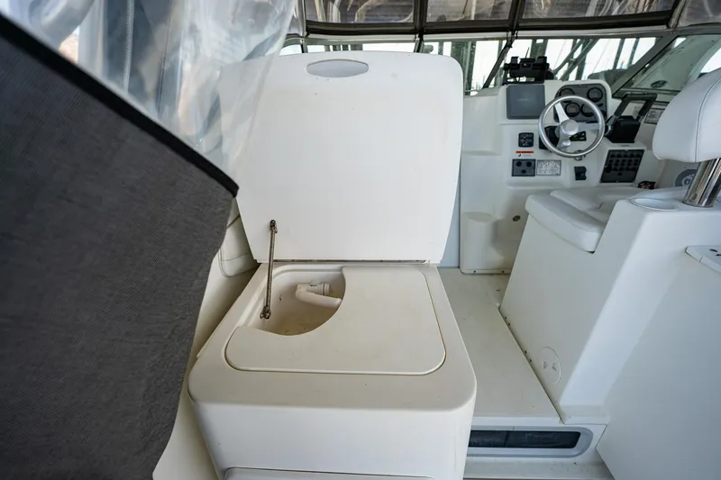 Slide: The Image of 2003 Aquasport 275 Explorer boat interior with helm and seating area. - 18