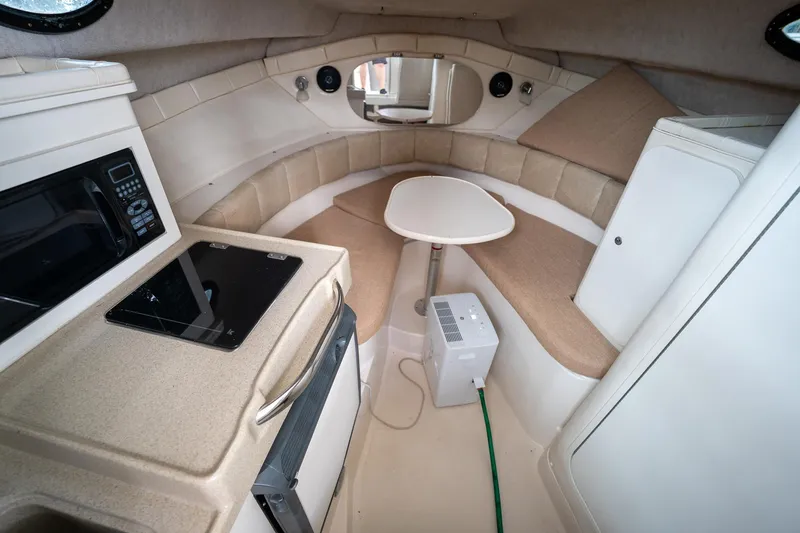 Slide: The Image of 2003 Aquasport 275 Explorer cabin interior with kitchenette and seating area. - 20