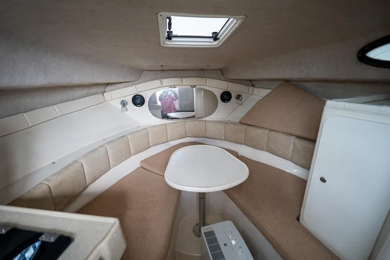Slide: The Image of 2003 Aquasport 275 Explorer cabin interior with seating and table. - 23