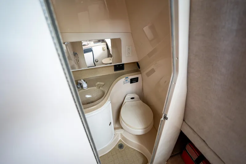 Slide: The Image of 2003 Aquasport 275 Explorer boat bathroom with sink, toilet, and mirror. - 24