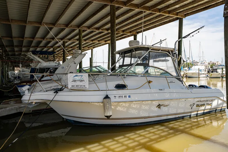 Slide: The Image of 2003 Aquasport 275 Explorer docked in a covered marina. - 4
