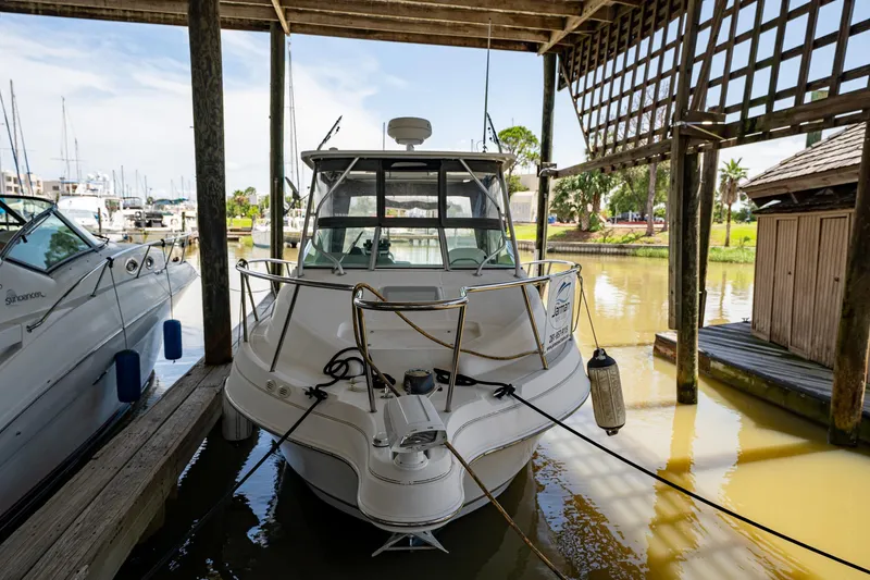 Slide: The Image of 2003 Aquasport 275 Explorer docked in a marina. - 6