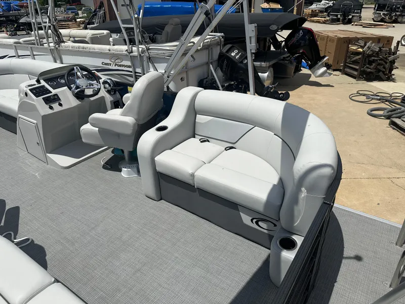 Slide: The Image of 2022 Crest Classic DLX 200 SLC pontoon boat interior with helm and seating area. - 11