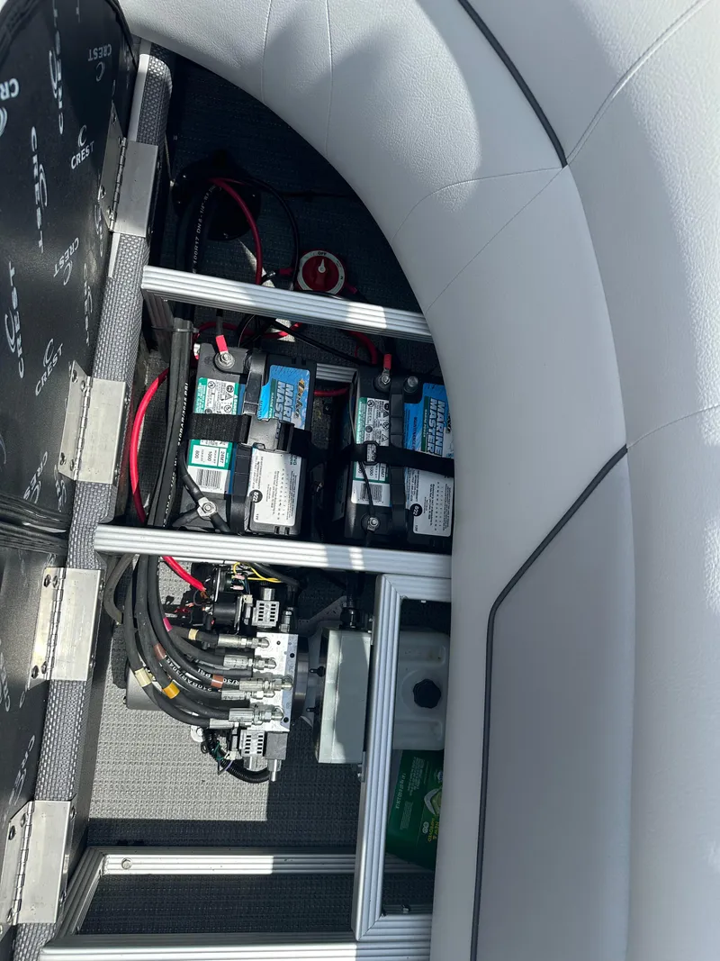 Slide: The Image of Battery compartment of a 2022 Crest Classic DLX 200 SLC pontoon boat. - 12