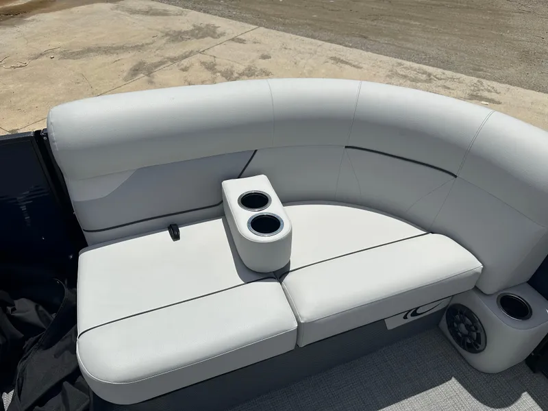 Slide: The Image of 2022 Crest Classic DLX 200 SLC boat with white cushioned seating and cup holders. - 13