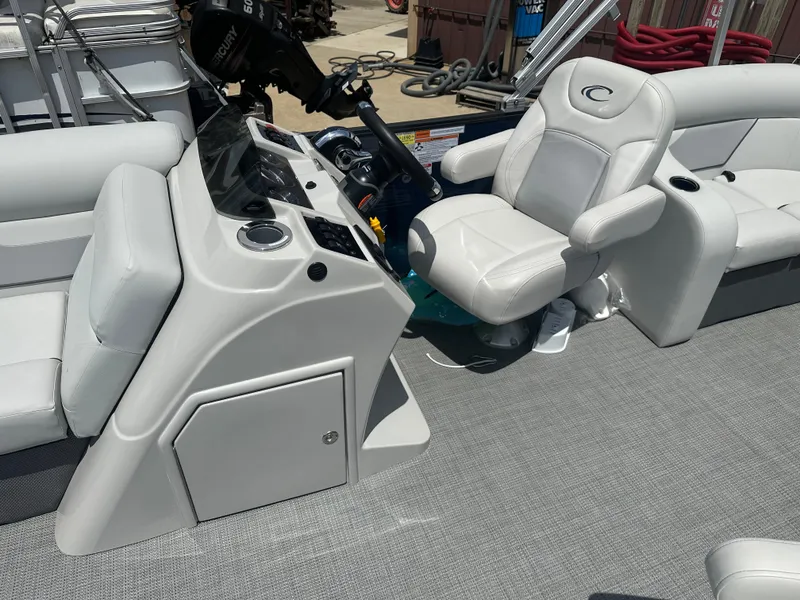 Slide: The Image of 2022 Crest Classic DLX 200 SLC boat interior with captain's chair and control console. - 6