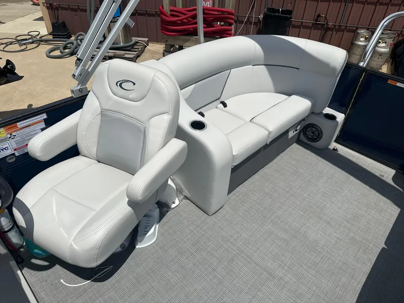 Slide: The Image of 2022 Crest Classic DLX 200 SLC boat interior with white leather seating. - 8