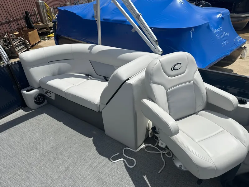 Slide: The Image of 2022 Crest Classic DLX 200 SLC boat interior with white leather seating. - 9