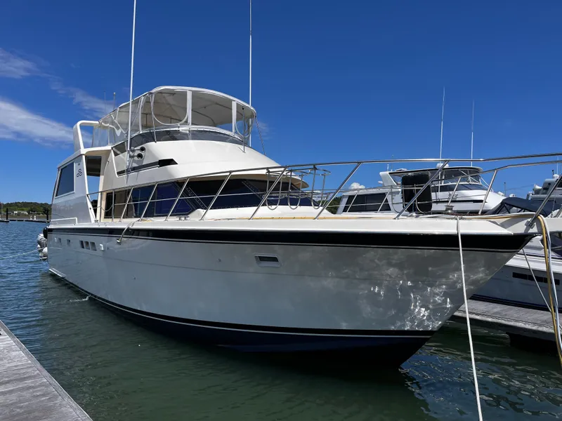 The Image of 1991 Hatteras 52 Cockpit Motoryacht docked under clear blue sky. - 0
