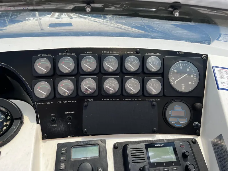 Slide: The Image of Control panel of a 1991 Hatteras 52 Cockpit Motoryacht with gauges and navigation equipment. - 12