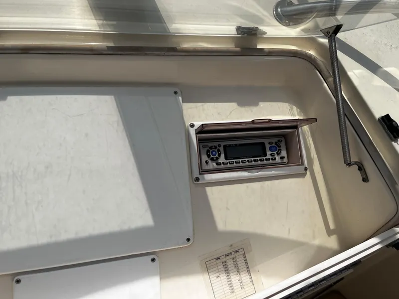 Slide: The Image of 1991 Hatteras 52 Cockpit Motoryacht control panel with radio and storage compartment. - 14