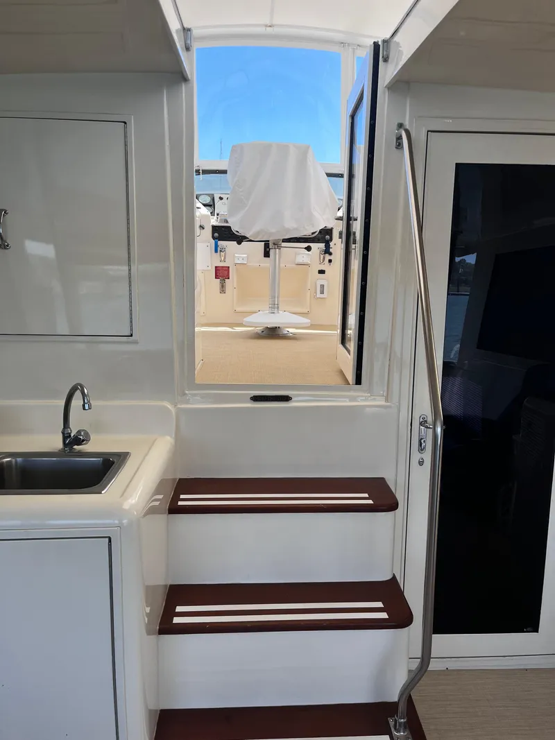 Slide: The Image of Interior view of 1991 Hatteras 52 Cockpit Motoryacht with stairs and sink. - 20