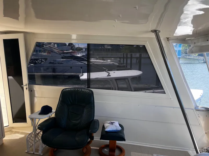 Slide: The Image of Interior of 1991 Hatteras 52 Cockpit Motoryacht with leather chair and window view. - 24