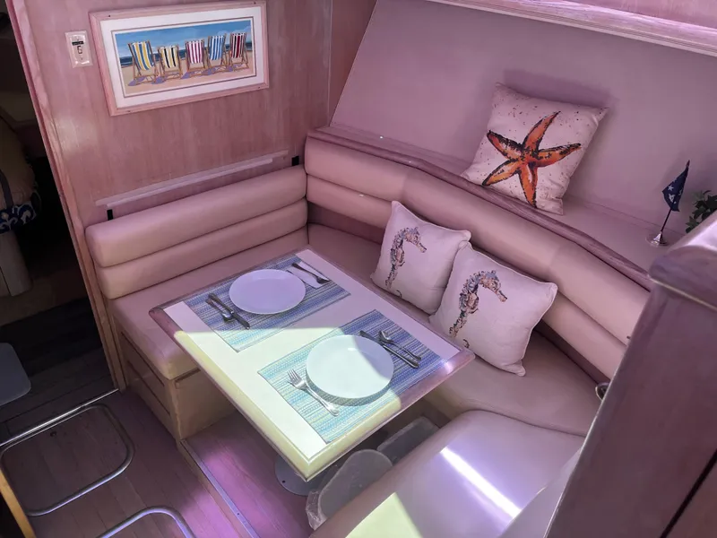 Slide: The Image of Interior of 1991 Hatteras 52 Cockpit Motoryacht with cozy dining area and nautical decor. - 30