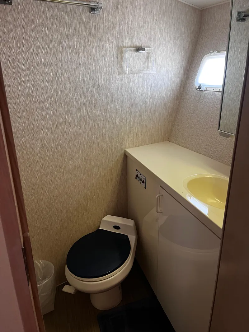 Slide: The Image of Bathroom interior of 1991 Hatteras 52 Cockpit Motoryacht with toilet and sink. - 33
