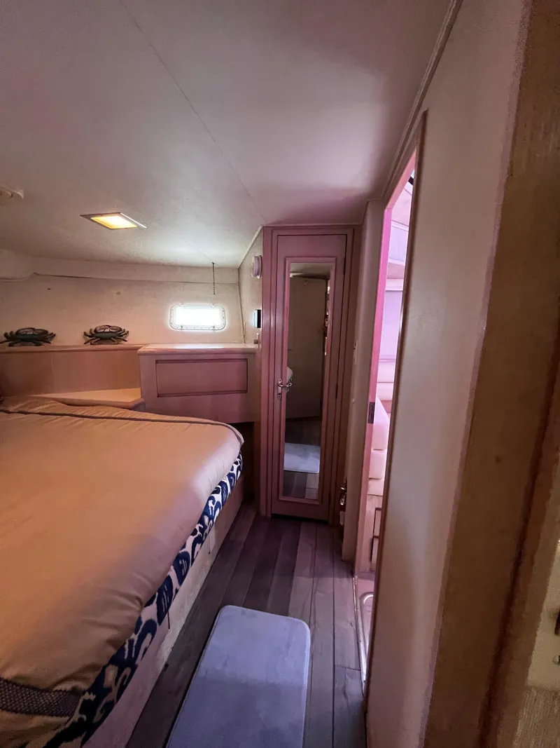 Slide: The Image of Cozy bedroom interior of 1991 Hatteras 52 Cockpit Motoryacht with wooden flooring. - 39
