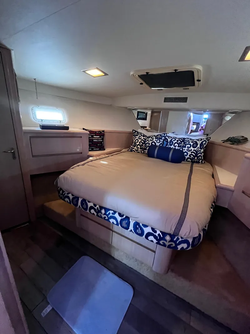 Slide: The Image of Luxurious bedroom interior of 1991 Hatteras 52 Cockpit Motoryacht with cozy bed and elegant decor. - 41