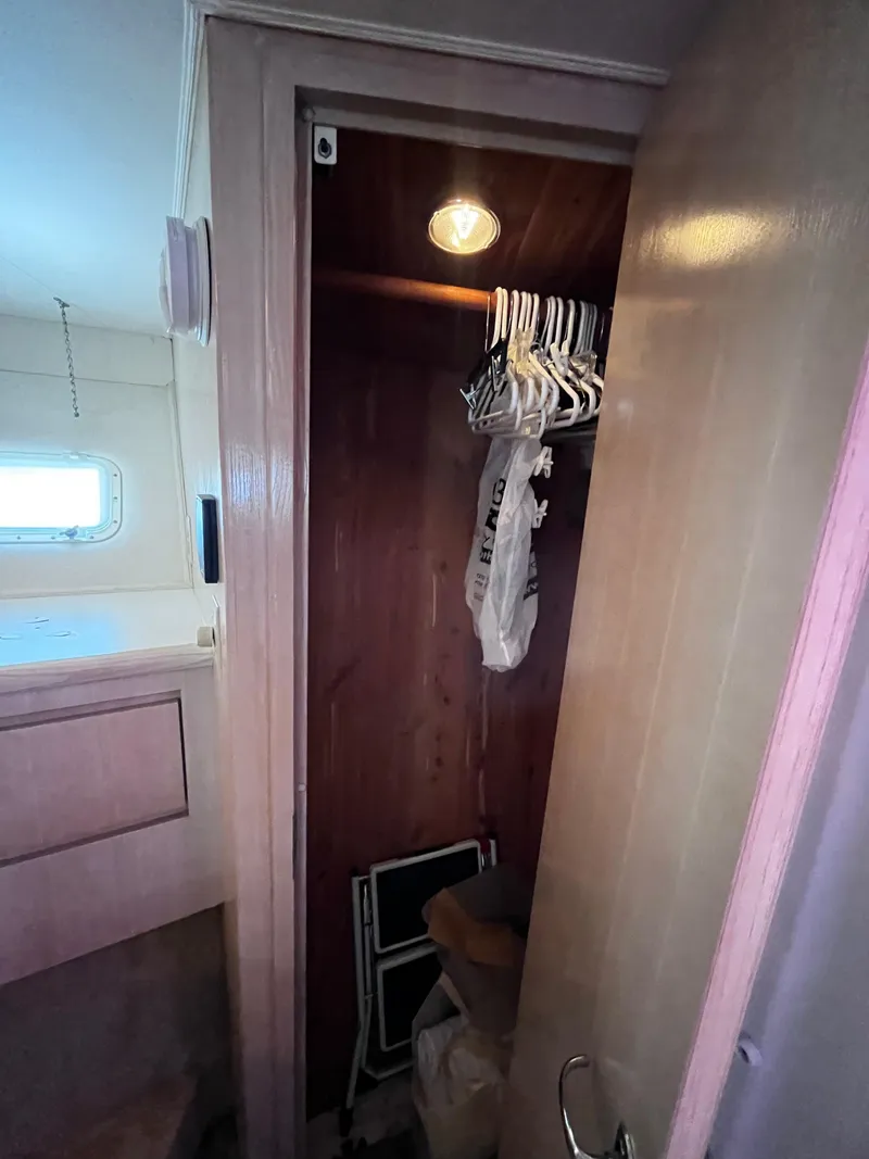 Slide: The Image of Closet interior on 1991 Hatteras 52 Cockpit Motoryacht with hangers and light. - 43