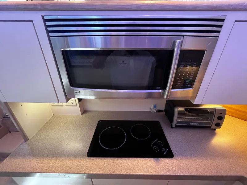 Slide: The Image of Modern kitchen in 1991 Hatteras 52 Cockpit Motoryacht with microwave, stovetop, and toaster oven. - 45