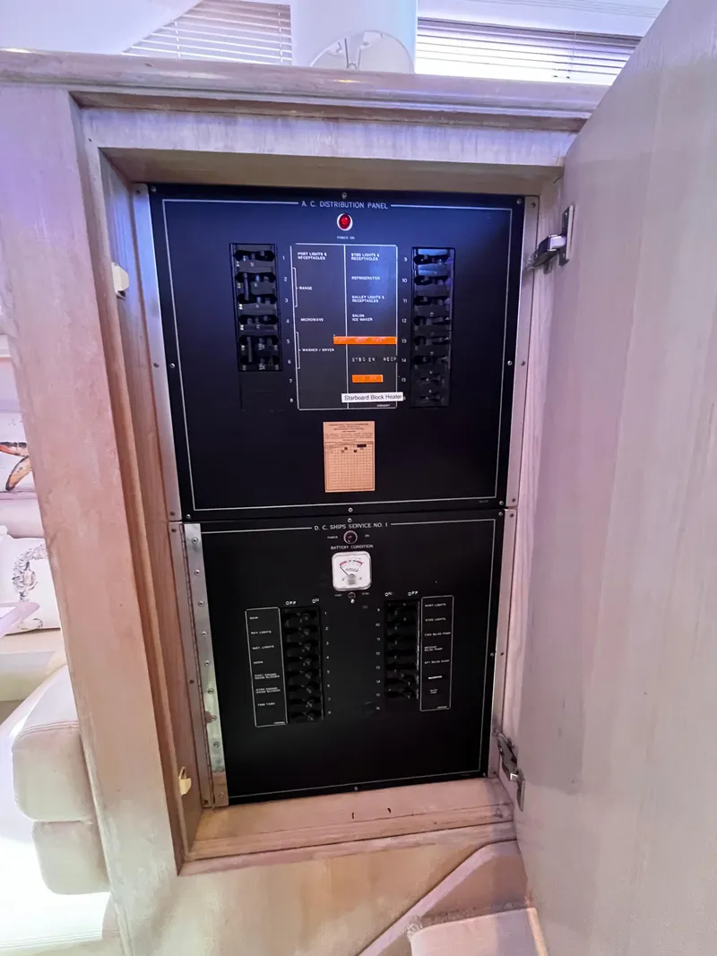 Slide: The Image of Electrical panel inside 1991 Hatteras 52 Cockpit Motoryacht, showcasing circuit breakers and controls. - 46