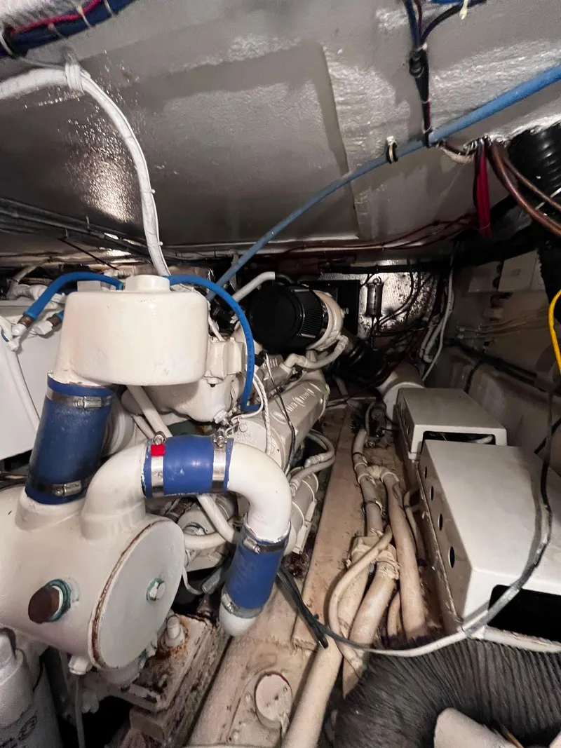 Slide: The Image of Engine room of 1991 Hatteras 52 Cockpit Motoryacht with visible machinery and wiring. - 48