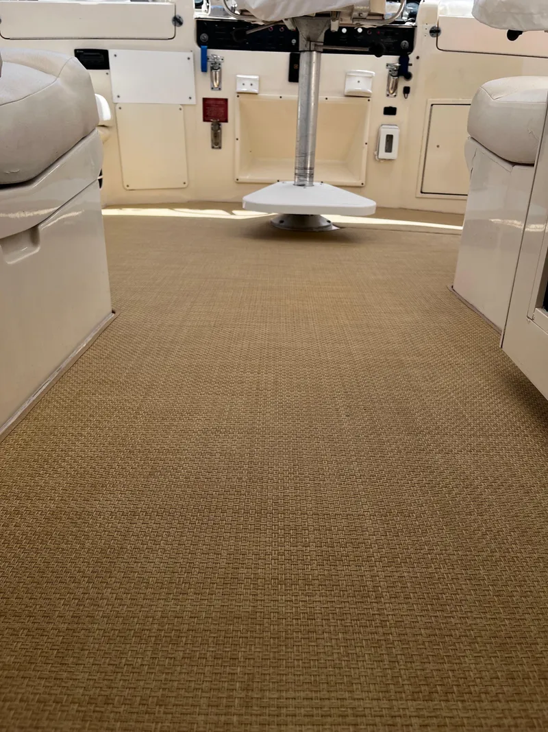 Slide: The Image of Interior view of 1991 Hatteras 52 Cockpit Motoryacht with beige carpet and seating. - 6