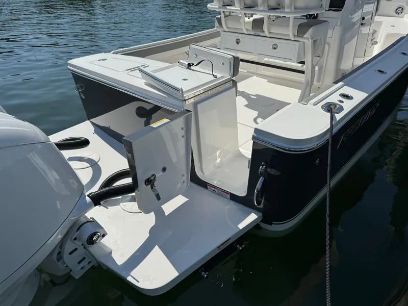 Slide: The Image of 2024 Regulator 23 boat with open transom door on calm water. - 14