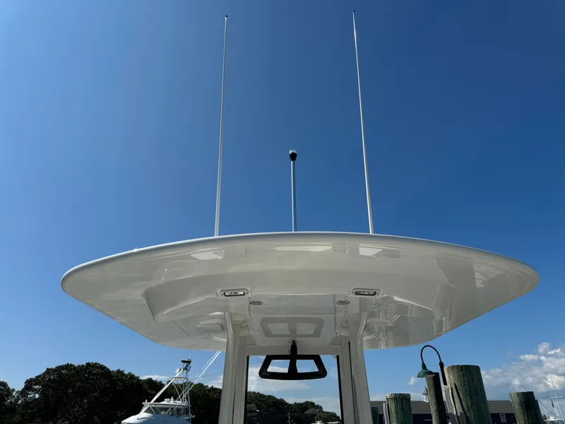 Slide: The Image of 2024 Regulator 23 boat with T-top against clear blue sky. - 20