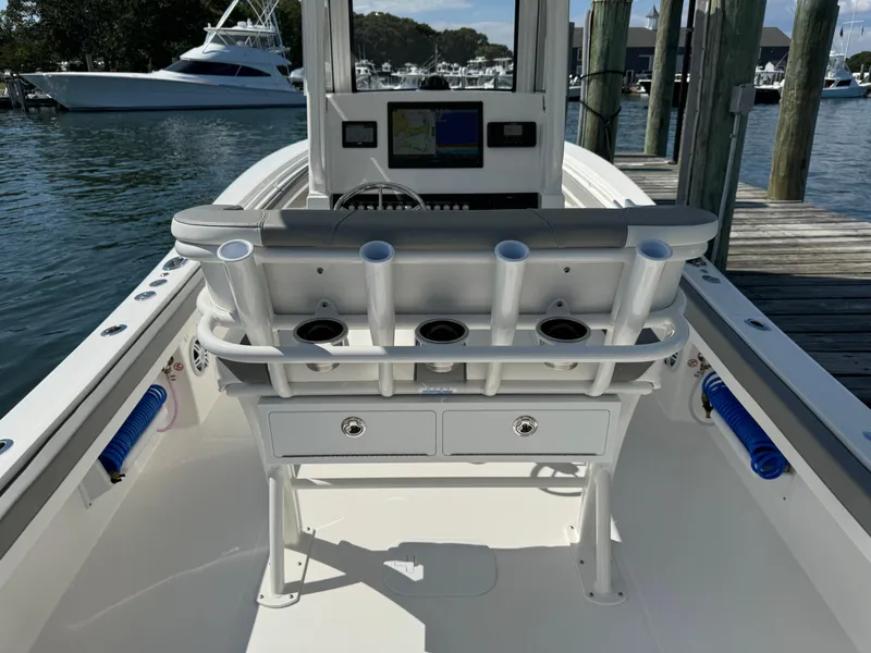 Slide: The Image of 2024 Regulator 23 boat interior with rod holders and navigation system at dock. - 21