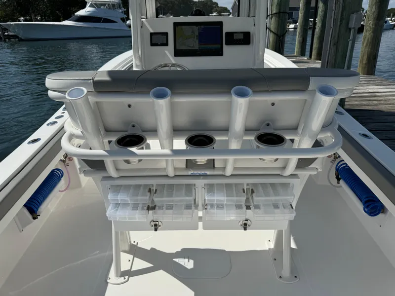 Slide: The Image of 2024 Regulator 23 boat interior with rod holders and storage compartments. - 22