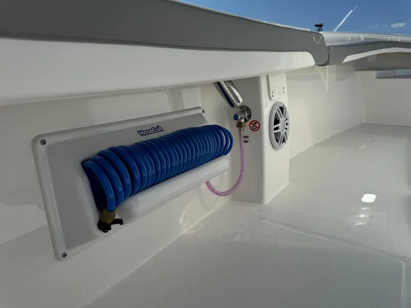Slide: The Image of 2024 Regulator 23 boat deck with coiled hose and speaker. - 25
