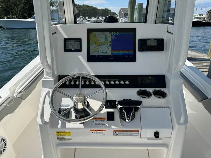 Slide: The Image of 2024 Regulator 23 boat dashboard with navigation screen and steering wheel. - 29