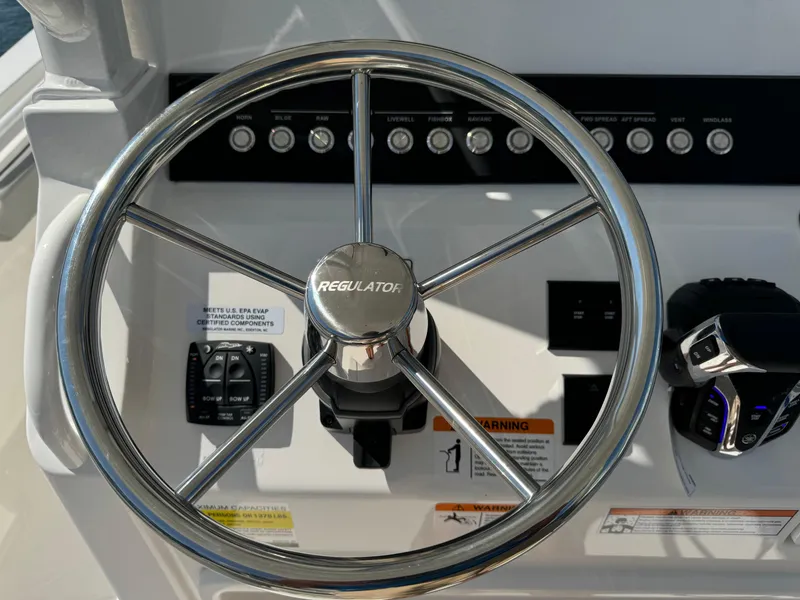 Slide: The Image of 2024 Regulator 23 boat steering wheel and control panel. - 31