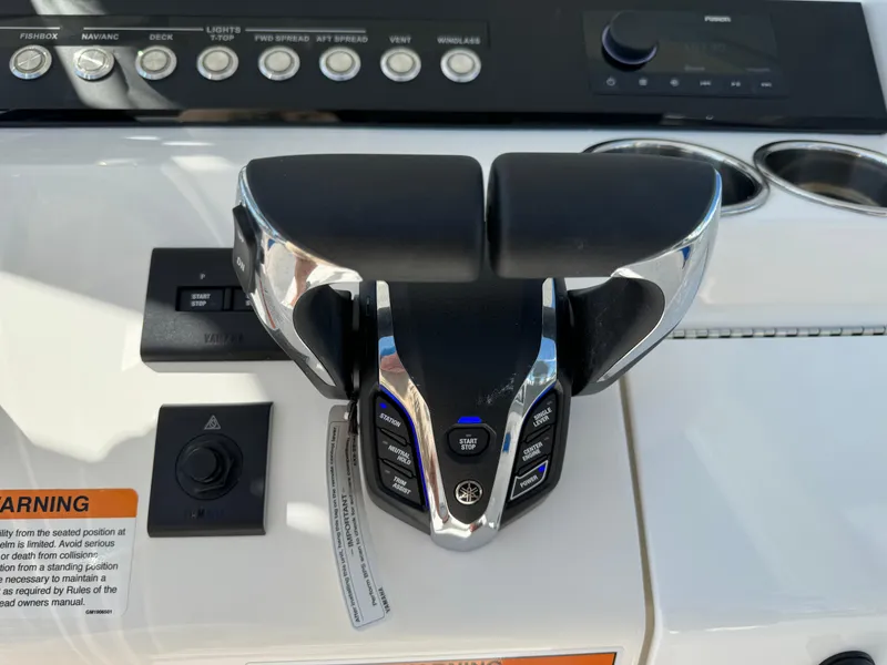 Slide: The Image of 2024 Regulator 23 boat throttle controls with modern dashboard features. - 33