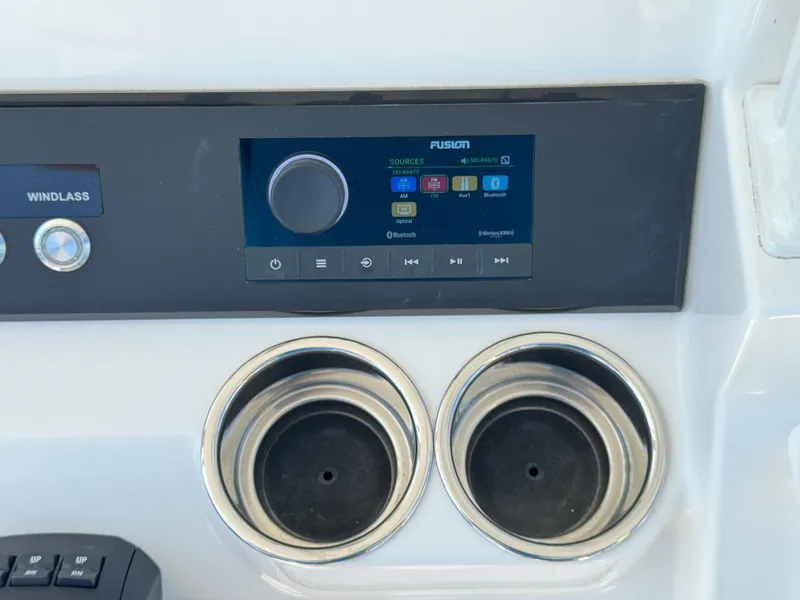 Slide: The Image of 2024 Regulator 23 boat dashboard with Fusion stereo and cup holders. - 34