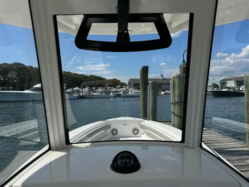 Slide: The Image of 2024 Regulator 23 boat docked at marina, viewed from helm. - 35